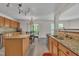 Open kitchen with stainless appliances, granite countertops, island, and a view of the outdoor patio at 1198 Shining Water Ln, Creedmoor, NC 27522