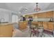 A kitchen with stainless steel appliances, a kitchen island, light-colored cabinets, and a dining table at 1198 Shining Water Ln, Creedmoor, NC 27522