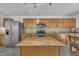 Well-lit kitchen featuring granite countertops, an island, stainless steel appliances, and abundant cabinet space at 1198 Shining Water Ln, Creedmoor, NC 27522