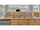 Close-up showcasing granite countertops, a stainless steel sink, and oak cabinets at 1198 Shining Water Ln, Creedmoor, NC 27522