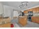 Charming kitchen boasts an island, granite countertops, stainless appliances, wood cabinets and open layout at 1198 Shining Water Ln, Creedmoor, NC 27522