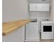 Well-organized laundry room with front-loading washer and dryer plus overhead cabinets at 1198 Shining Water Ln, Creedmoor, NC 27522
