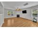 Bright living room with fireplace, ceiling fan, and hardwood floors at 1198 Shining Water Ln, Creedmoor, NC 27522