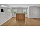 Open living area features hardwood floors, neutral walls, and large windows at 1198 Shining Water Ln, Creedmoor, NC 27522