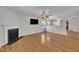 Spacious living room with fireplace, hardwood floors, archways, a fan and a television at 1198 Shining Water Ln, Creedmoor, NC 27522