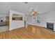 The open-concept living room features an archway into the kitchen, a fireplace and access to the back deck at 1198 Shining Water Ln, Creedmoor, NC 27522