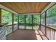 Screened deck features a wood ceiling and flooring, surrounded by lush greenery for outdoor enjoyment at 1198 Shining Water Ln, Creedmoor, NC 27522