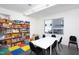 Bright activity room with a large table and shelves filled with games and toys at 130 Hunt St # 107, Durham, NC 27701