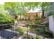 Private backyard featuring multi-level landscaping, lush greenery, and serene garden setting, perfect for relaxation at 130 Hunt St # 107, Durham, NC 27701