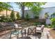 Charming backyard featuring a stone patio, comfortable seating, and mature trees, creating an inviting outdoor retreat at 130 Hunt St # 107, Durham, NC 27701