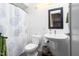 Simple bathroom featuring a shower with patterned curtain, pedestal sink, and neutral decor, maximizing functionality at 130 Hunt St # 107, Durham, NC 27701