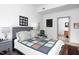 Cozy bedroom featuring a comfortable bed with decorative quilt, neutral walls, and a glimpse into the ensuite at 130 Hunt St # 107, Durham, NC 27701