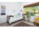 Inviting bedroom with a single bed, bright window views, and vintage decor accents, offering a relaxing atmosphere at 130 Hunt St # 107, Durham, NC 27701