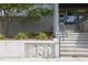 Building entrance with modern design, featuring a concrete planter with address number at 130 Hunt St # 107, Durham, NC 27701