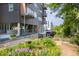 Exterior view of a modern apartment building with balconies and lush landscaping at 130 Hunt St # 107, Durham, NC 27701