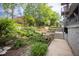 Lush community garden with varied plants, elevated beds and walking path at 130 Hunt St # 107, Durham, NC 27701