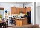 Well-equipped kitchen with modern appliances and bar stool seating at 130 Hunt St # 107, Durham, NC 27701