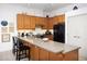 Bright kitchen featuring wood cabinetry, sleek countertops, and modern appliances, offering a functional space at 130 Hunt St # 107, Durham, NC 27701