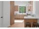 Modern kitchen with light wood cabinets, marble countertops, and stainless steel appliances at 1302 Chamblee Hill Ct, Raleigh, NC 27608