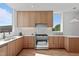 Contemporary kitchen with light wood cabinets, marble counters, and stainless steel range at 1302 Chamblee Hill Ct, Raleigh, NC 27608
