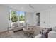 Bright living room with large windows, stylish furniture, and hardwood floors at 1302 Chamblee Hill Ct, Raleigh, NC 27608