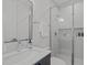 Bathroom featuring a glass enclosed shower, modern vanity, and tile walls at 1303 Chamblee Hill Ct, Raleigh, NC 27608