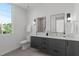 Modern bathroom with double vanity, stylish mirrors, and large window at 1303 Chamblee Hill Ct, Raleigh, NC 27608