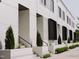 Charming townhome exterior features neat landscaping, symmetrical design, and eye-catching brickwork at 1303 Chamblee Hill Ct, Raleigh, NC 27608