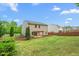 Spacious backyard with a view of the house, shed, and patio with pergola at 1307 Torrey Pines Ct, Mebane, NC 27302