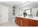 Well-lit bathroom featuring a double vanity, built in storage, and separate toilet room at 1307 Torrey Pines Ct, Mebane, NC 27302
