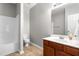 Clean bathroom with modern vanity, tile flooring, and shower with white surround at 1307 Torrey Pines Ct, Mebane, NC 27302