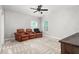 Bright bedroom with carpeting, ceiling fan and comfortable leather chairs at 1307 Torrey Pines Ct, Mebane, NC 27302