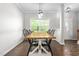 Bright dining area showcasing wood floors, a large window, and a stylish, rustic-modern table at 1307 Torrey Pines Ct, Mebane, NC 27302