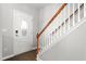 Welcoming entryway featuring wood flooring, a staircase with wooden banister, and a decorative front door at 1307 Torrey Pines Ct, Mebane, NC 27302