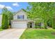 Charming two-story home featuring a two-car garage, well-maintained lawn, and traditional siding at 1307 Torrey Pines Ct, Mebane, NC 27302