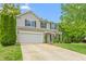 Inviting two-story home boasts a two-car garage, neat landscaping, and a welcoming front porch at 1307 Torrey Pines Ct, Mebane, NC 27302