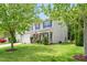 Charming two-story home featuring a well-manicured lawn, vinyl siding, black shutters, and an attached two-car garage at 1307 Torrey Pines Ct, Mebane, NC 27302
