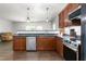 Modern kitchen featuring dark wood cabinets, granite countertops, stainless steel appliances, and an open layout at 1307 Torrey Pines Ct, Mebane, NC 27302