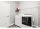 Well-organized laundry area featuring modern appliances and ample shelving for storage at 1307 Torrey Pines Ct, Mebane, NC 27302