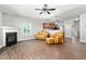 Open-concept living space with fireplace, hardwood floors, and an open view to the kitchen at 1307 Torrey Pines Ct, Mebane, NC 27302