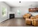 Inviting living room with fireplace, hardwood floors, and adjacent kitchen area at 1307 Torrey Pines Ct, Mebane, NC 27302