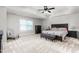 This primary bedroom features a tray ceiling, neutral carpet and a large window at 1307 Torrey Pines Ct, Mebane, NC 27302