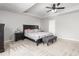 This primary bedroom features a tray ceiling, neutral carpet and black furniture at 1307 Torrey Pines Ct, Mebane, NC 27302