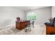 Well-lit office space featuring a dark wood desk and a pair of mid-century modern chairs at 1307 Torrey Pines Ct, Mebane, NC 27302
