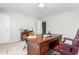 This home office features a dark wood desk, a red leather chair and modern lighting at 1307 Torrey Pines Ct, Mebane, NC 27302