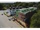 New construction aerial view showing multi-Gathering brick building with rooftop decks and nearby street at 1308 Chamblee Hill Ct, Raleigh, NC 27608