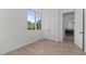 Bright bedroom with large windows, hardwood floors, and a closet in a modern home at 1308 Chamblee Hill Ct, Raleigh, NC 27608