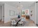 Open-concept dining area featuring stylish lighting and an adjacent kitchen, perfect for modern living at 1308 Chamblee Hill Ct, Raleigh, NC 27608