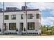Modern, three-story townhouse with stylish white brick and contemporary black framed windows at 1308 Chamblee Hill Ct, Raleigh, NC 27608