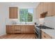 Bright kitchen with stainless steel oven, stylish cabinetry, and large window for ample natural light at 1308 Chamblee Hill Ct, Raleigh, NC 27608